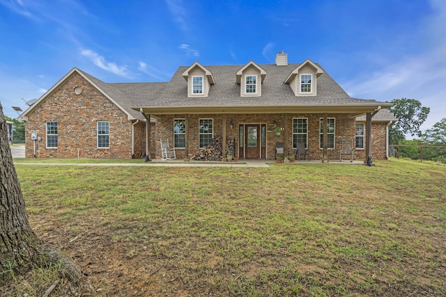 cape cod home featuring a front lawn