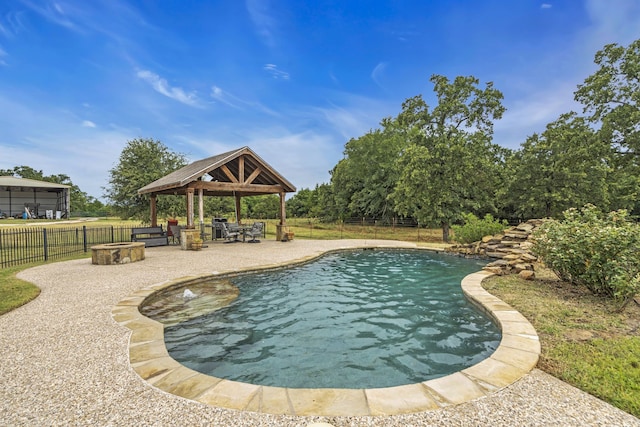 view of swimming pool with a gazebo, a patio area, and a fire pit