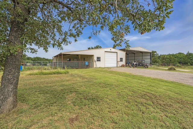 exterior space with a garage and an outbuilding