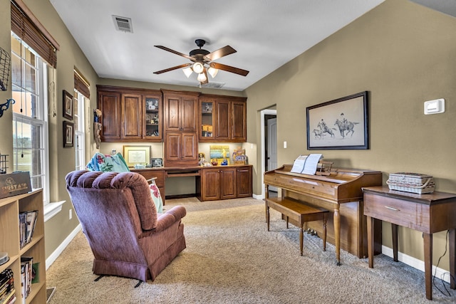 interior space with built in desk and ceiling fan