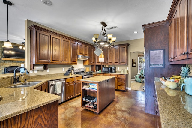 kitchen featuring stainless steel appliances, decorative light fixtures, a center island, and sink