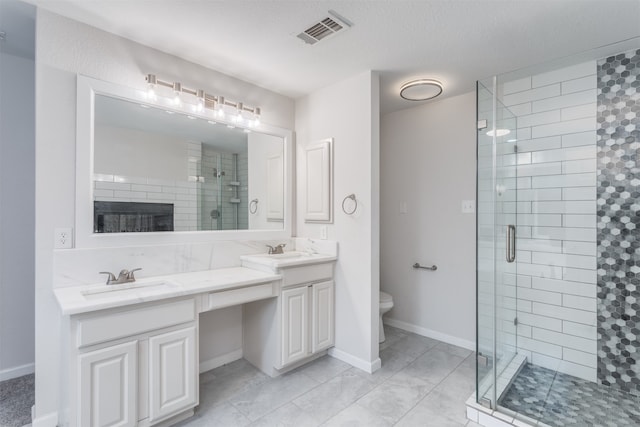 bathroom with tile patterned flooring, toilet, an enclosed shower, and dual bowl vanity