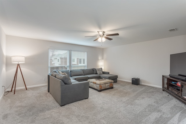 carpeted living room featuring ceiling fan