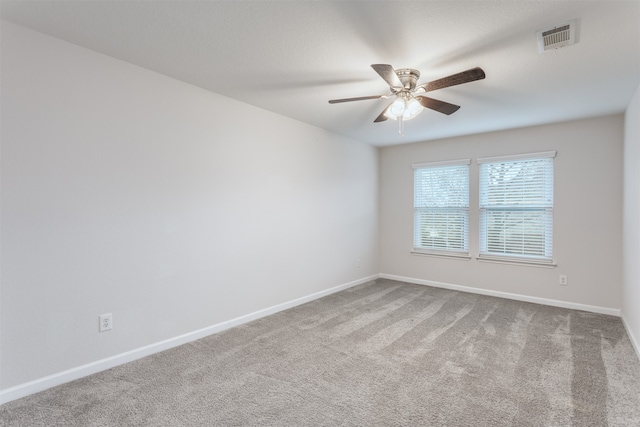 empty room featuring carpet floors and ceiling fan