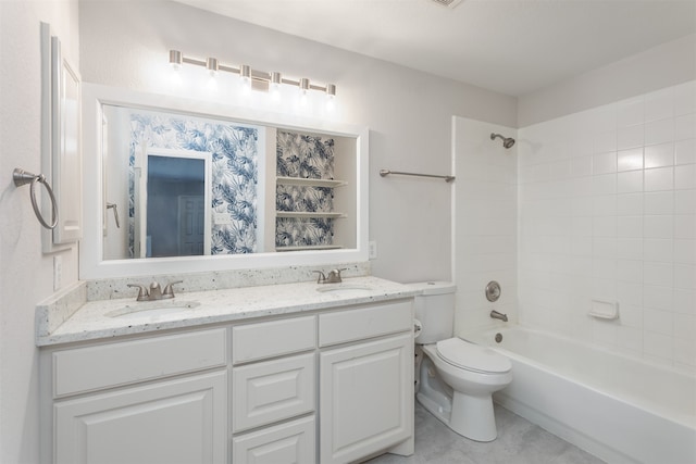 full bathroom with double vanity, toilet, tiled shower / bath, and tile patterned floors