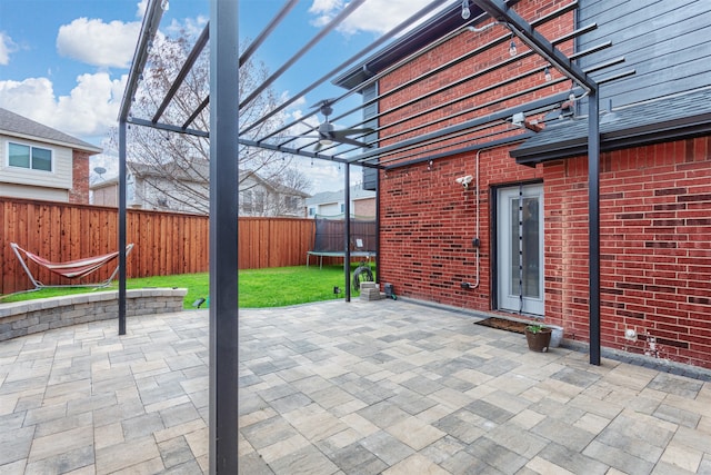 view of patio / terrace featuring a pergola and a trampoline