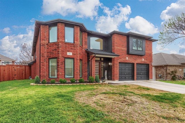 view of front of property with a garage and a front lawn