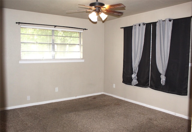 spare room with carpet floors and ceiling fan