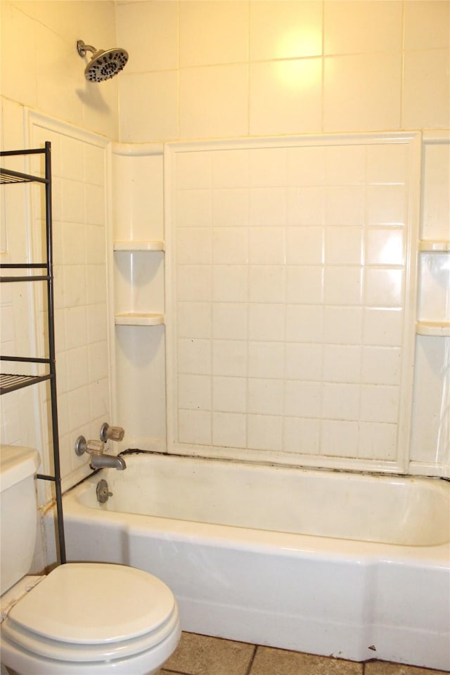 bathroom featuring toilet and tiled shower / bath combo