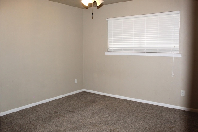 spare room featuring ceiling fan and carpet flooring