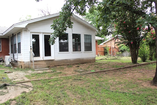 rear view of property with a yard