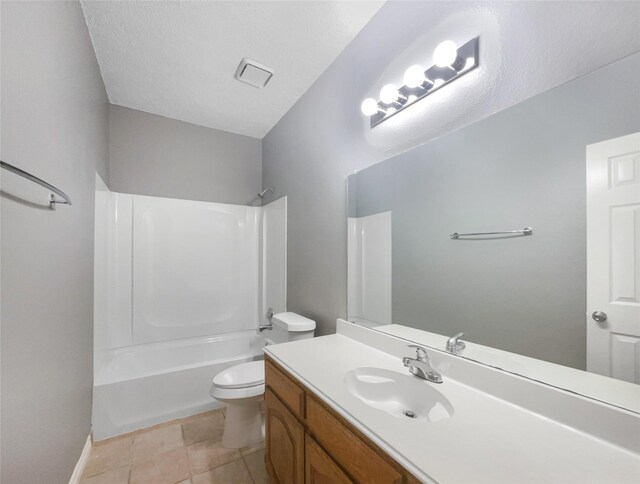 full bathroom with a textured ceiling, vanity, bathing tub / shower combination, tile patterned flooring, and toilet