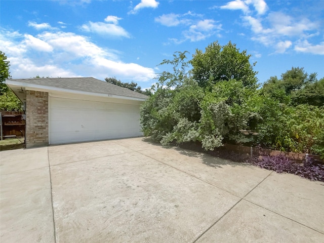 view of side of home featuring a garage