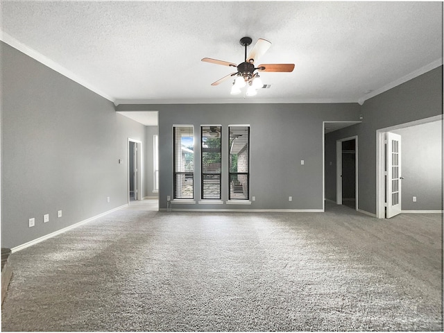 carpeted empty room with a textured ceiling, ceiling fan, and ornamental molding