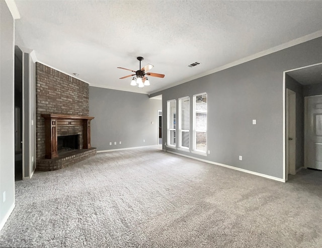 unfurnished living room with a fireplace, a textured ceiling, ceiling fan, and ornamental molding