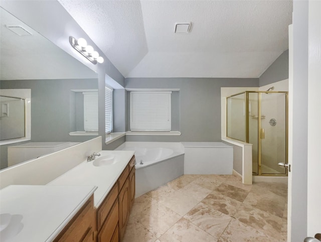 bathroom featuring a textured ceiling, plus walk in shower, vanity, and vaulted ceiling