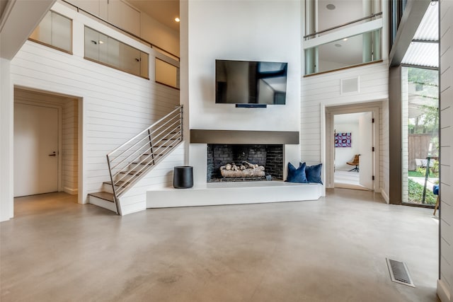 unfurnished living room featuring concrete floors