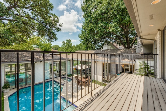 wooden terrace featuring a fenced in pool