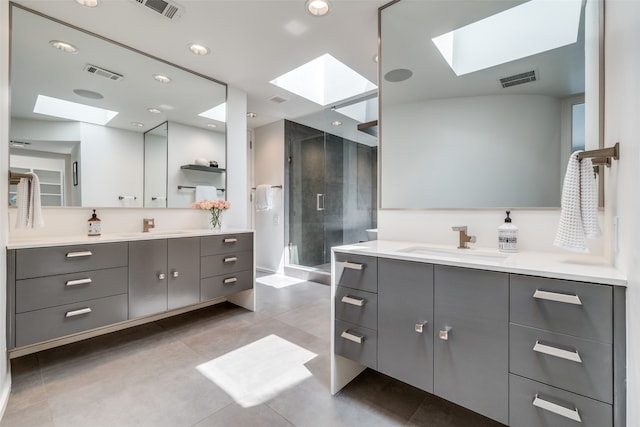 bathroom featuring a skylight, tile patterned flooring, and vanity