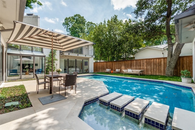 view of swimming pool with a patio and a hot tub