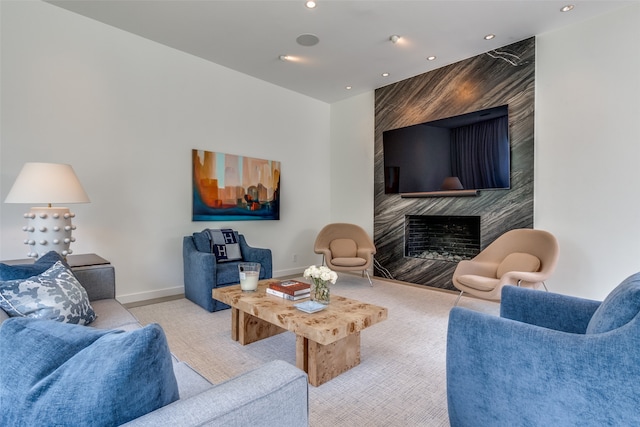 living room with carpet flooring and a fireplace