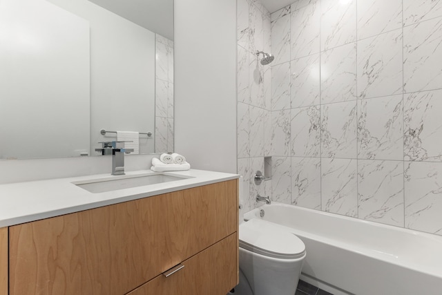 full bathroom featuring vanity, tiled shower / bath, tile patterned flooring, and toilet