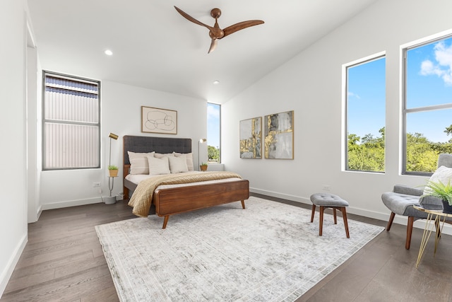 bedroom with ceiling fan, hardwood / wood-style flooring, and vaulted ceiling