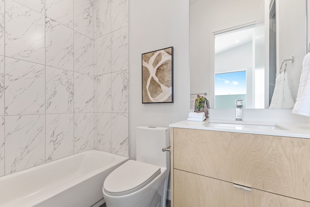 full bathroom with vanity, tiled shower / bath, and toilet