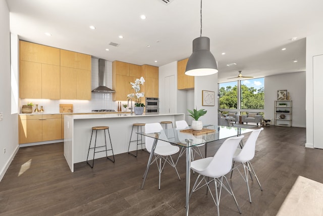 dining area with dark hardwood / wood-style floors and ceiling fan