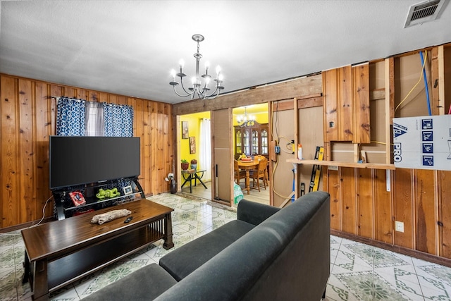 living room with wooden walls and a chandelier