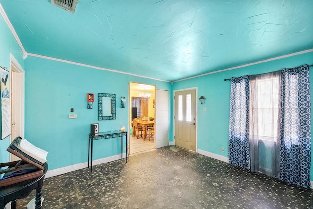 interior space with ornamental molding and a chandelier