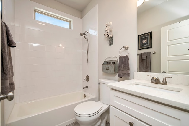 full bathroom featuring vanity, tiled shower / bath, and toilet