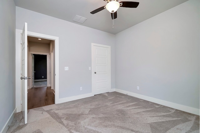 unfurnished bedroom with carpet, a closet, and ceiling fan