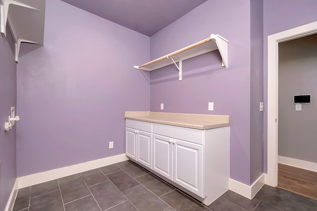 laundry area featuring dark wood-type flooring