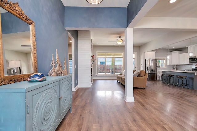 foyer with ceiling fan and wood-type flooring