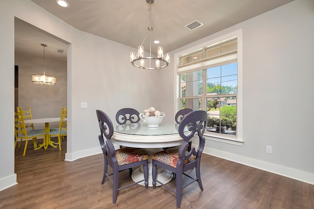 dining space with an inviting chandelier and dark wood-type flooring