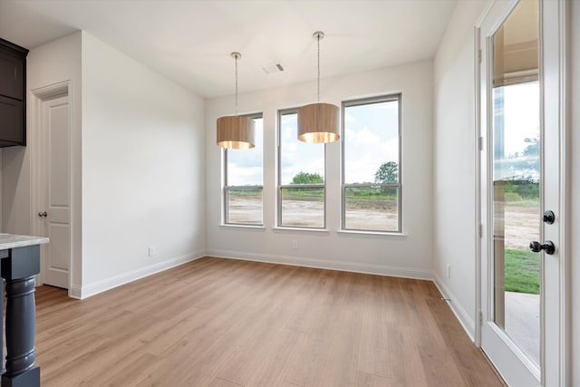 unfurnished dining area featuring light hardwood / wood-style flooring