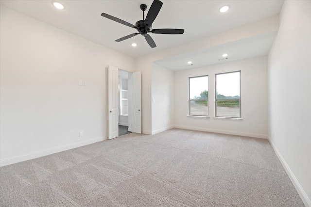 unfurnished bedroom with ceiling fan and light colored carpet