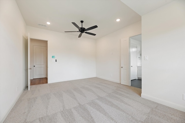 carpeted spare room featuring ceiling fan