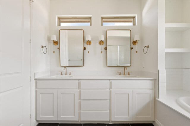 bathroom with a wealth of natural light, vanity, and a bath