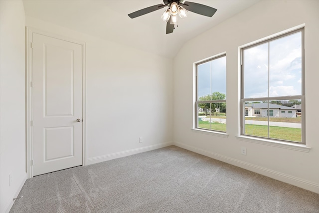 spare room with lofted ceiling, ceiling fan, and carpet floors