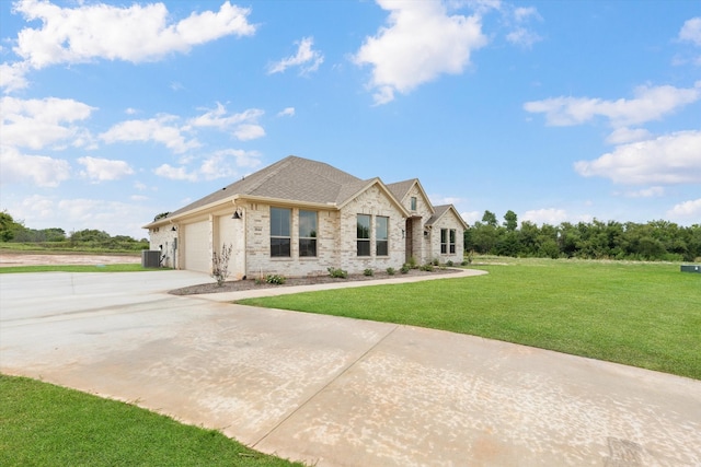 view of front facade with cooling unit, a front yard, and a garage