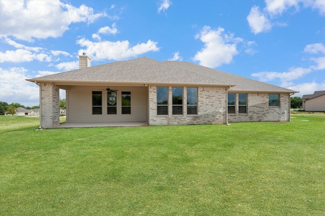 rear view of house featuring a yard and a patio