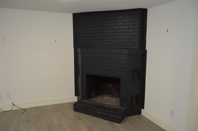 interior space with a fireplace and wood-type flooring