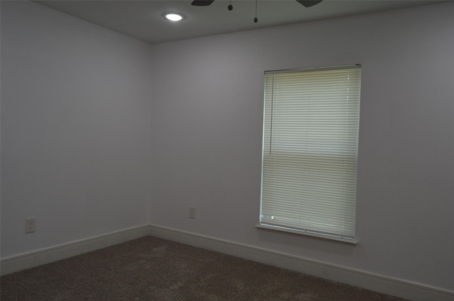 empty room with ceiling fan and carpet