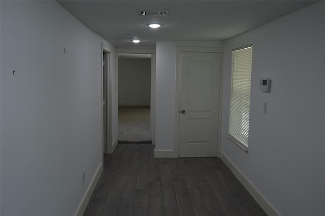 corridor featuring dark hardwood / wood-style floors