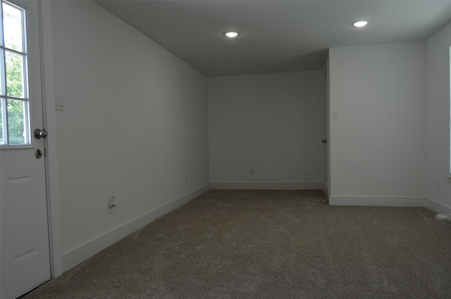 carpeted spare room featuring plenty of natural light