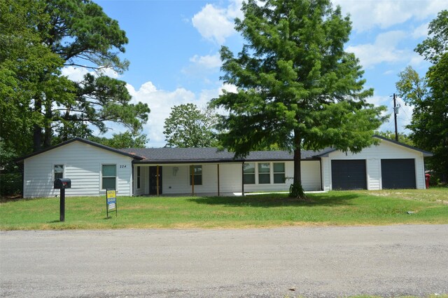 single story home with a garage and a front yard