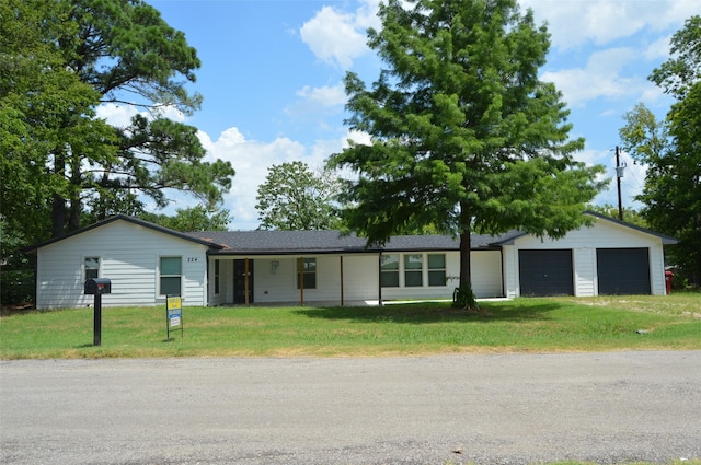 single story home with a garage and a front lawn