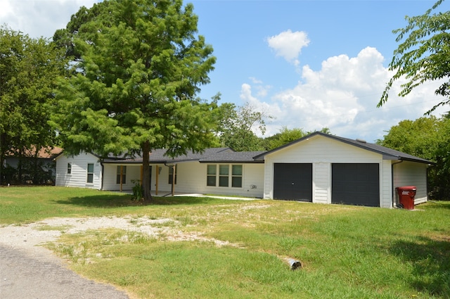 exterior space featuring a garage and a lawn